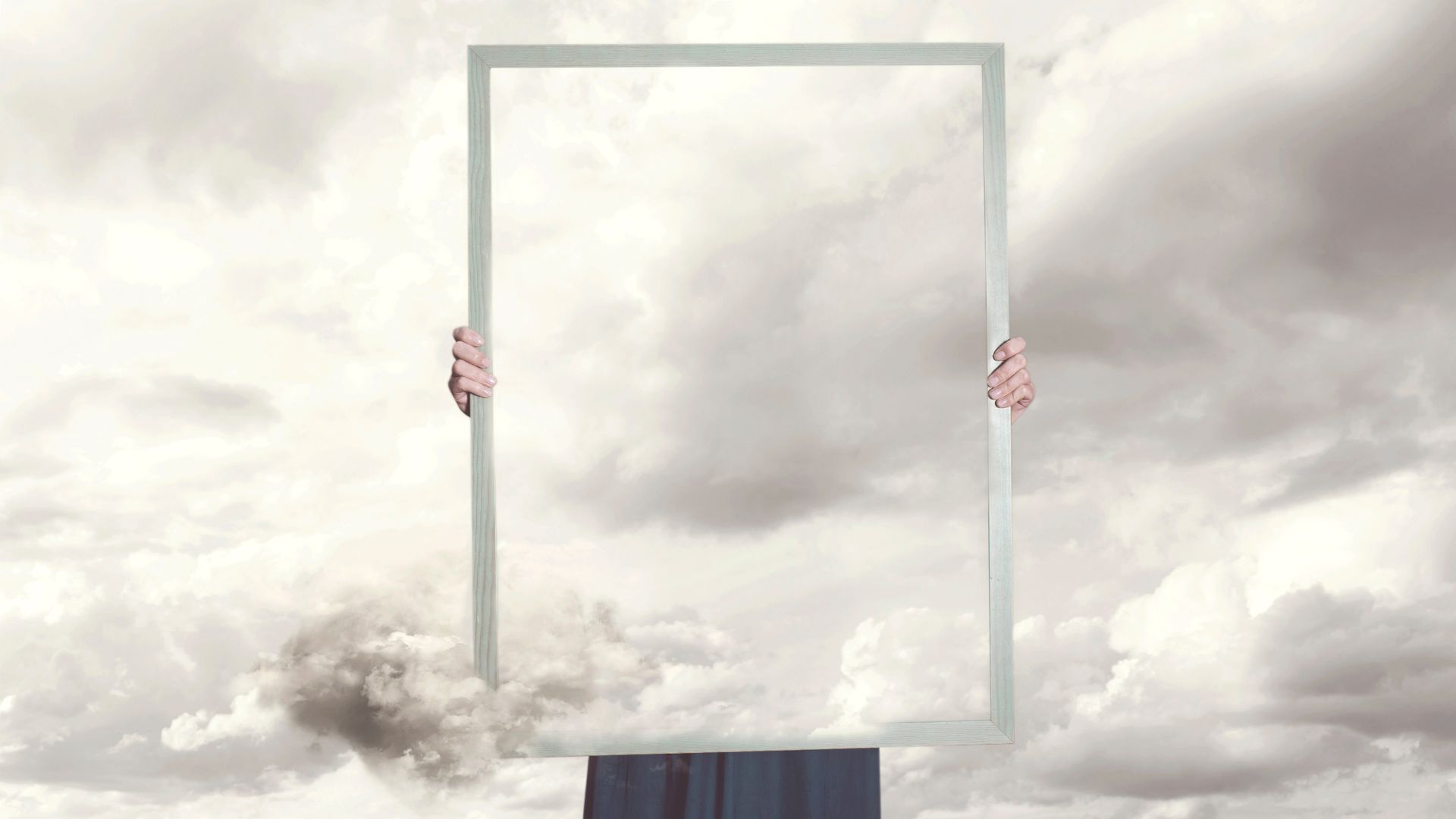Image of an invisible man holding a frame with nothing in it